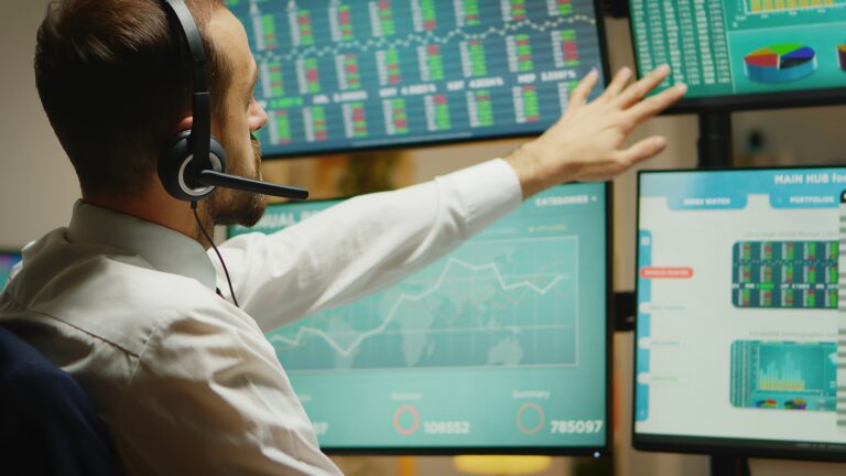 Broker with headphones checking the stock market